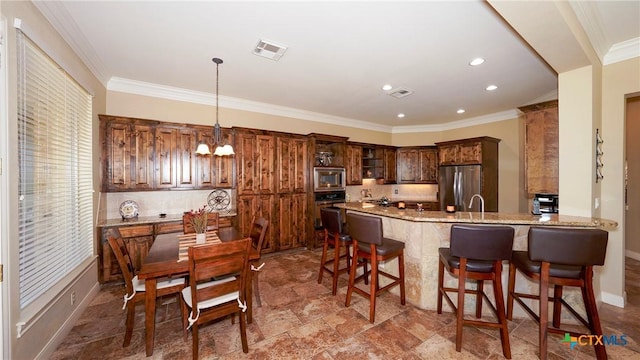 kitchen with hanging light fixtures, stainless steel appliances, light stone counters, kitchen peninsula, and ornamental molding