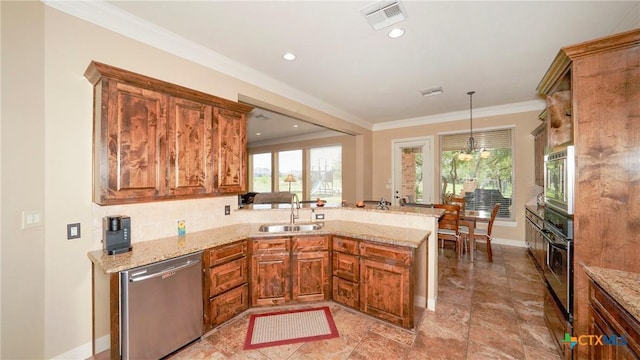 kitchen featuring kitchen peninsula, light stone counters, stainless steel appliances, sink, and decorative light fixtures