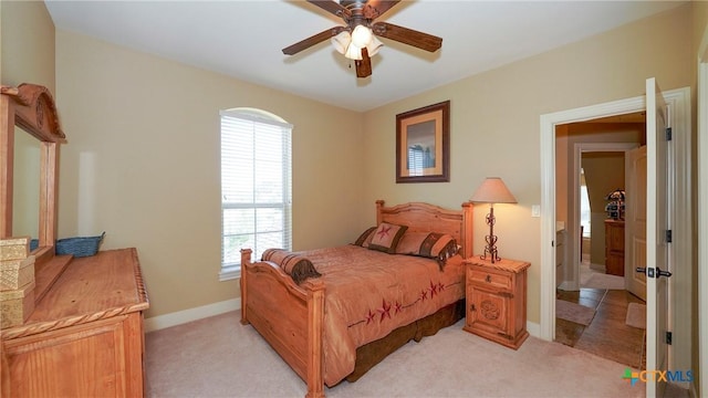 bedroom with ceiling fan and light carpet