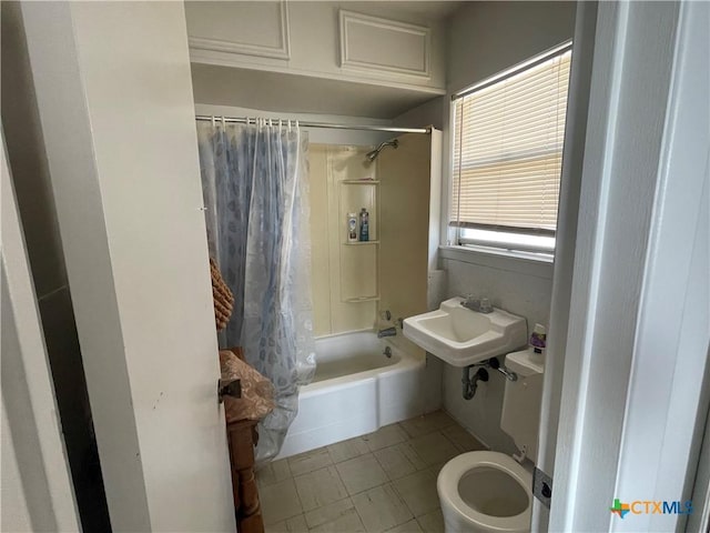 full bathroom with tile patterned floors, toilet, shower / bathtub combination with curtain, and sink