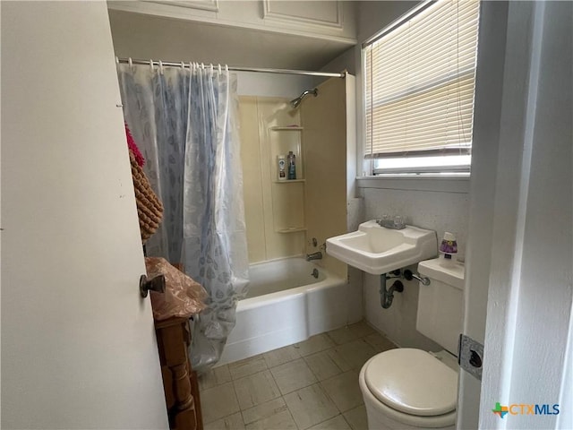 full bathroom with sink, shower / bath combination with curtain, and toilet