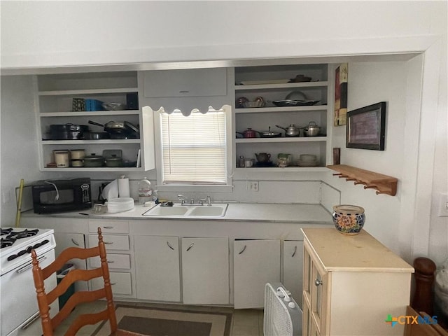 kitchen with white gas range and sink