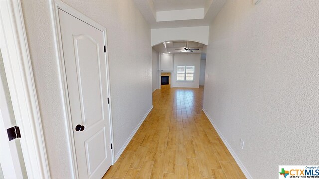 808 Dred Roger Cir, Killeen, TX 76542 - corridor with arched walkways, light wood-style floors, baseboards, and a textured wall