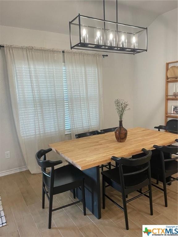 dining room featuring light hardwood / wood-style floors and an inviting chandelier