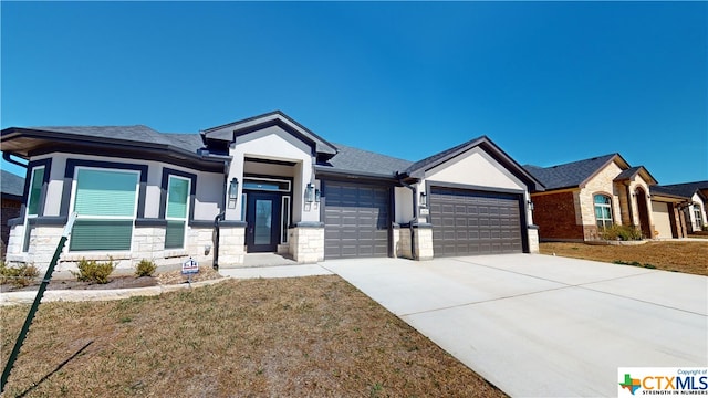 808 Dred Roger Cir, Killeen, TX 76542 - view of front of property with an attached garage, stone siding, driveway, a front yard, and stucco siding