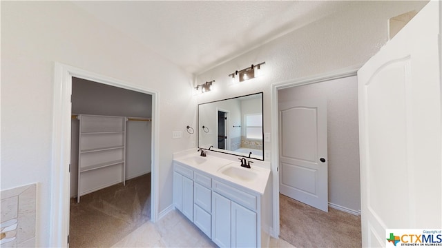 808 Dred Roger Cir, Killeen, TX 76542 - bathroom featuring double vanity and a walk in closet