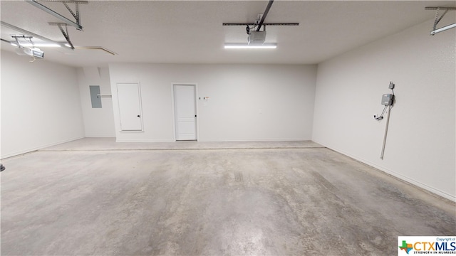 garage featuring electric panel and a garage door opener