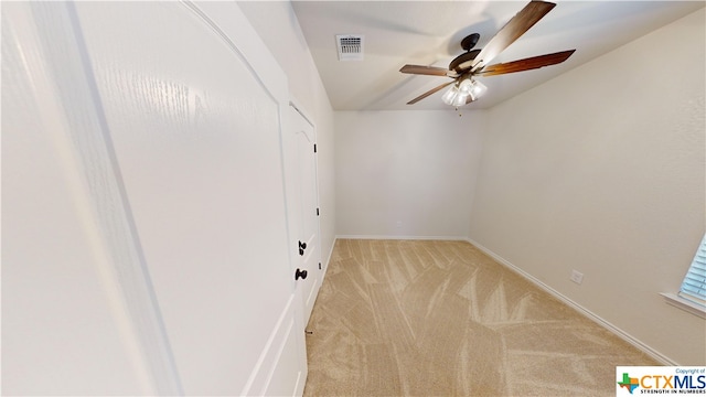 empty room featuring light carpet and ceiling fan