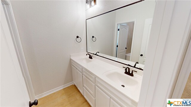 808 Dred Roger Cir, Killeen, TX 76542 - bathroom featuring double vanity, baseboards, and a textured wall