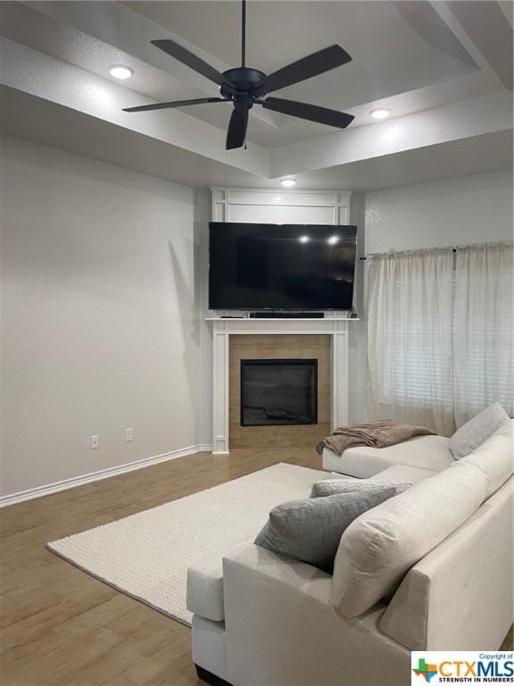 living room featuring ceiling fan and wood-type flooring