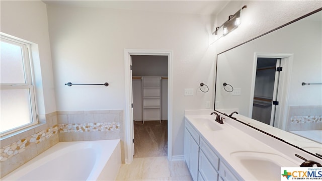 808 Dred Roger Cir, Killeen, TX 76542 - full bath featuring a walk in closet, a garden tub, double vanity, and baseboards