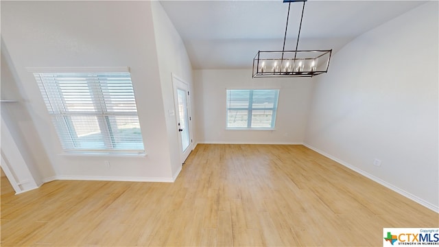 808 Dred Roger Cir, Killeen, TX 76542 - unfurnished dining area with a chandelier, light wood finished floors, lofted ceiling, and baseboards