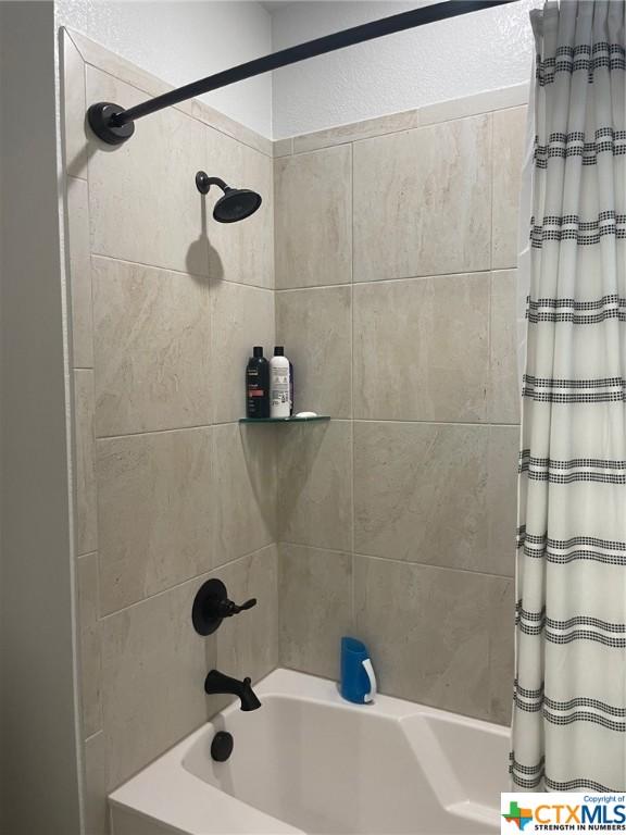 bathroom featuring shower / tub combo with curtain