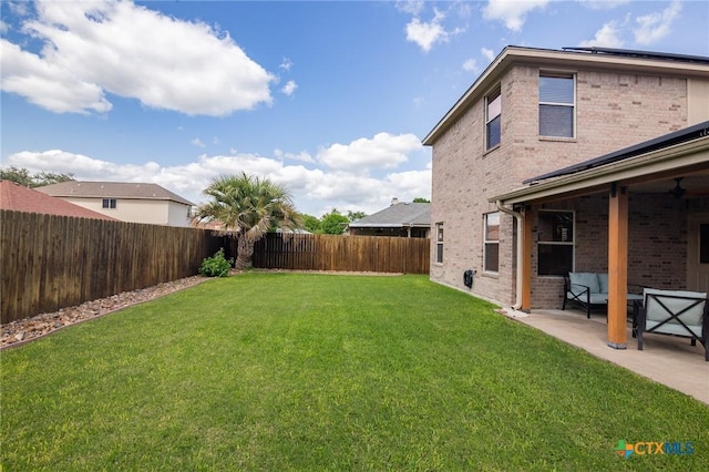 view of yard with a patio, a fenced backyard, and an outdoor living space