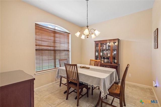 dining room featuring light tile patterned floors, baseboards, and a chandelier