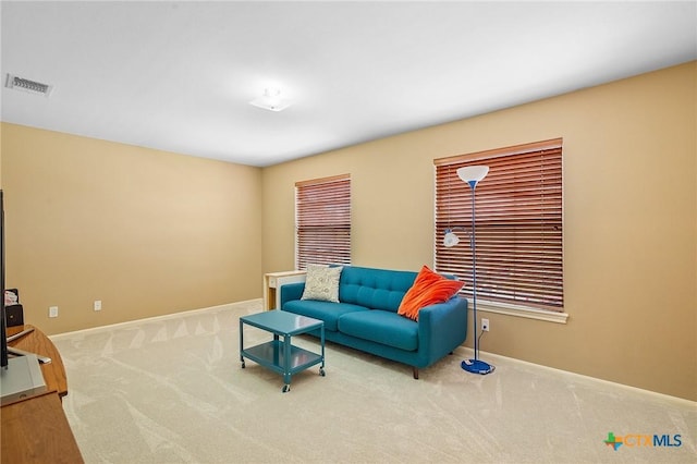 living area with carpet flooring, baseboards, and visible vents