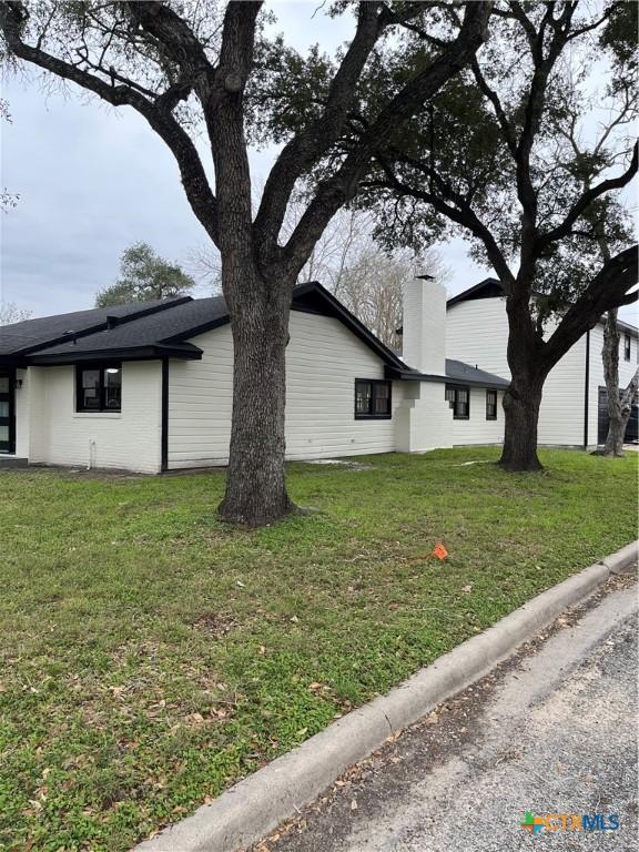 view of side of home featuring a yard