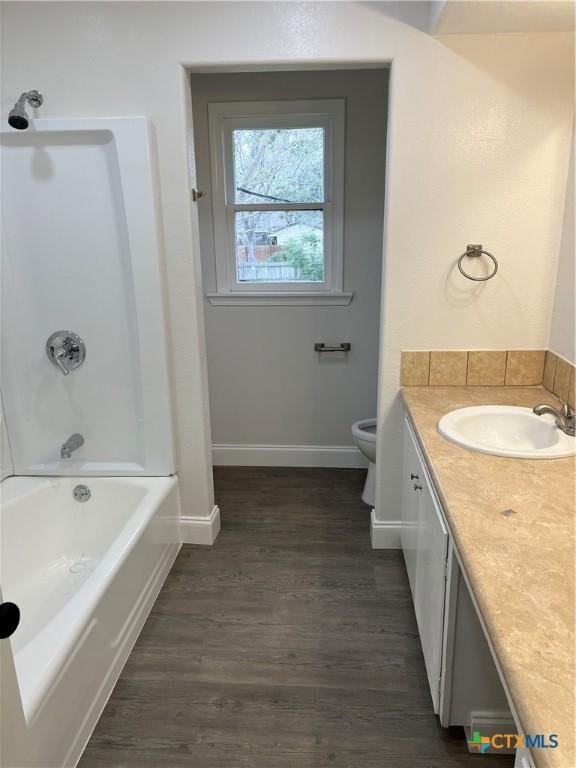 bathroom with vanity, wood-type flooring, and toilet