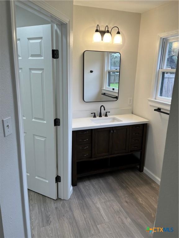 bathroom featuring vanity and hardwood / wood-style floors