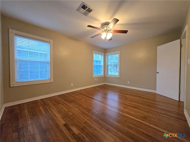 spare room featuring dark hardwood / wood-style flooring and ceiling fan