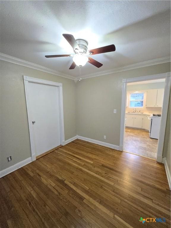 empty room featuring hardwood / wood-style flooring and ornamental molding