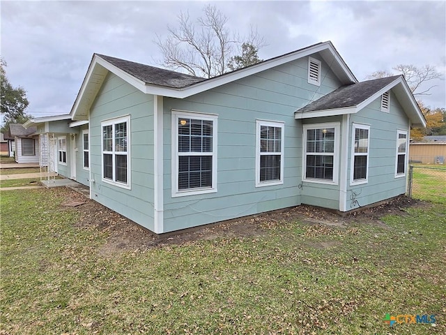 view of property exterior with a yard