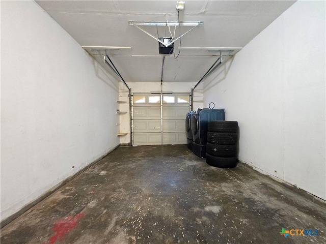 garage with a garage door opener and washer / clothes dryer