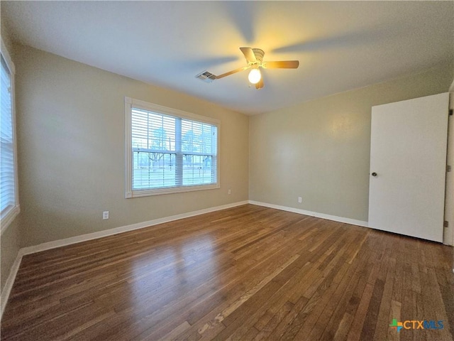 unfurnished room with dark wood-type flooring and ceiling fan