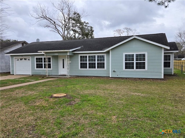 single story home featuring a garage and a front lawn