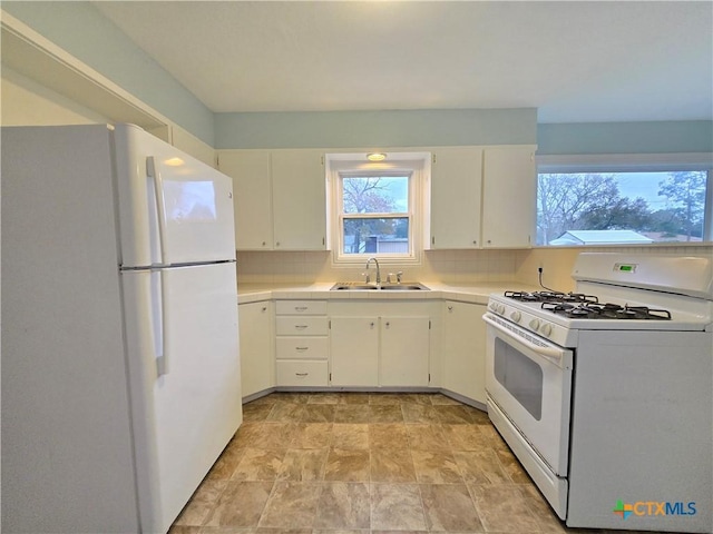 kitchen featuring white cabinetry, white appliances, sink, and decorative backsplash