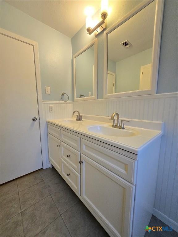 bathroom featuring tile patterned flooring and vanity