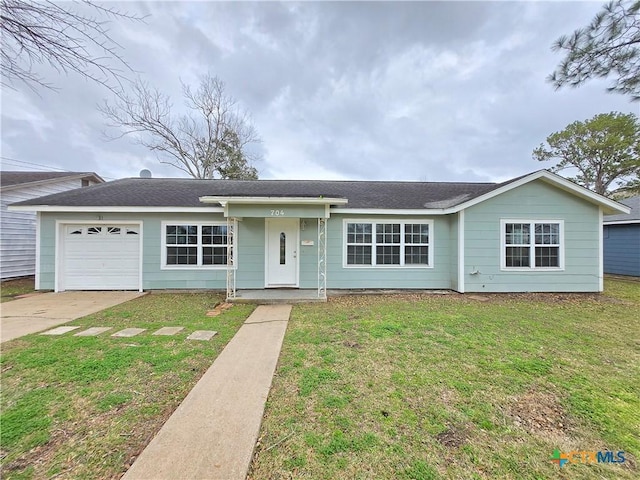 ranch-style house featuring a garage and a front yard