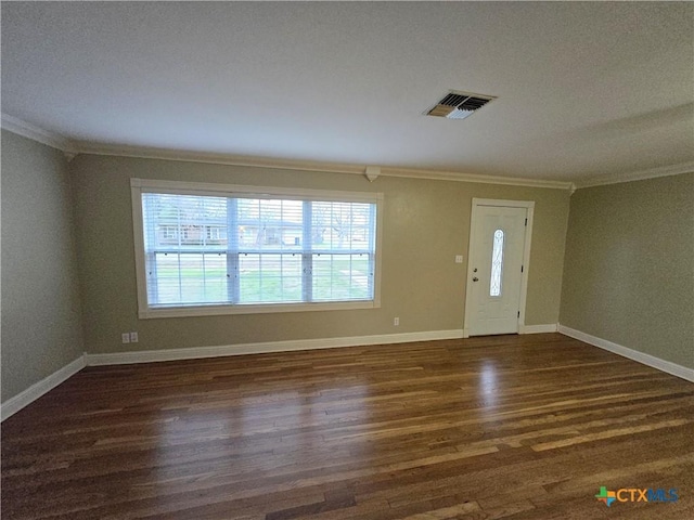 entrance foyer featuring dark wood-type flooring and ornamental molding