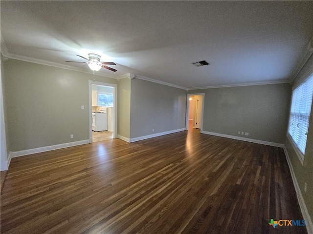 empty room with ornamental molding, a healthy amount of sunlight, and dark hardwood / wood-style flooring