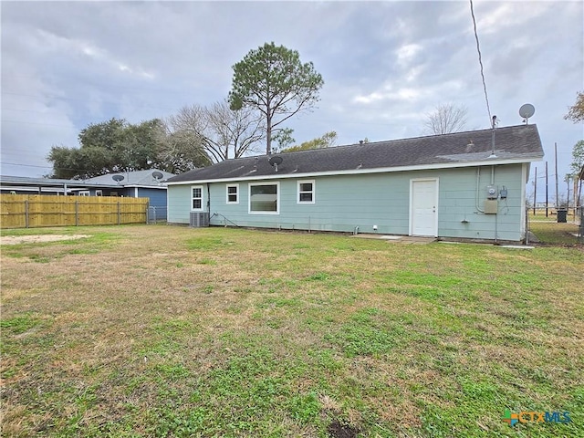 rear view of house with a yard