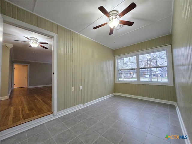 empty room with tile patterned floors and ceiling fan