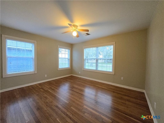 unfurnished room with ceiling fan and dark hardwood / wood-style flooring