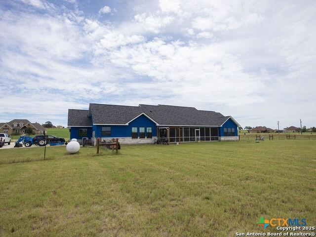 228 Triple R Dr, La Vernia, TX 78121 - back of property featuring a yard