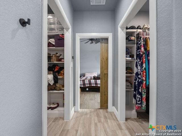 228 Triple R Dr, La Vernia, TX 78121 - corridor with wood finished floors and a textured wall