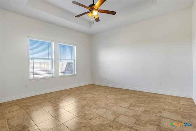 1102 Indian Mallow Dr, Temple, TX 76502 - empty room featuring a raised ceiling, baseboards, and ceiling fan