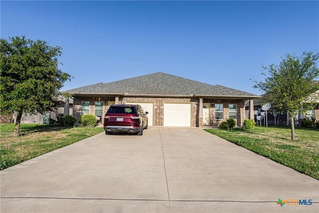 1102 Indian Mallow Dr, Temple, TX 76502 - ranch-style home featuring roof with shingles, an attached garage, driveway, brick siding, and a front yard