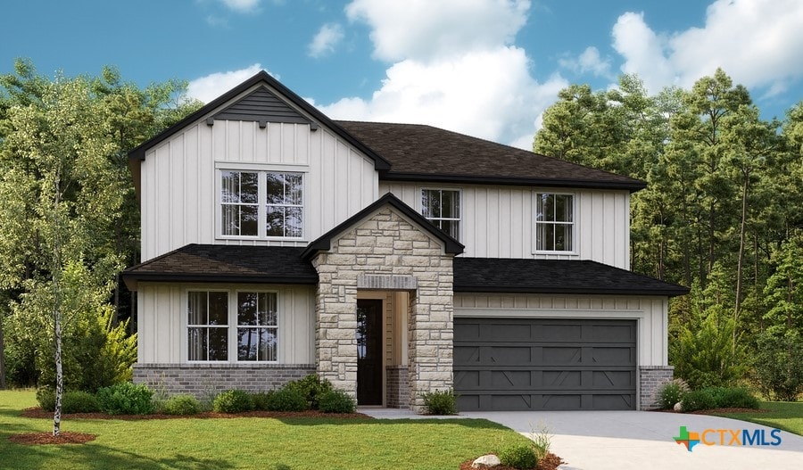 view of front of property with a garage and a front yard