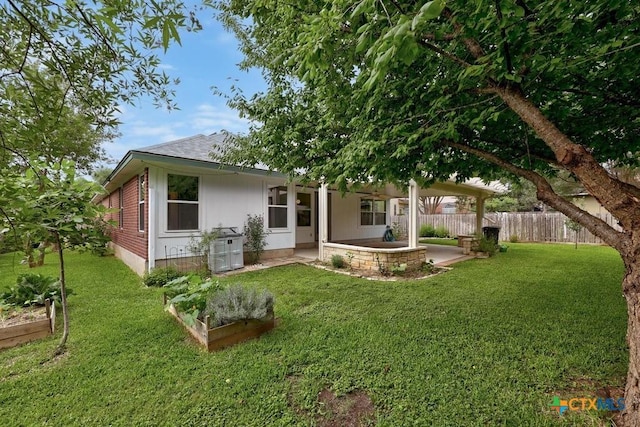 9100 Brimstone Ln, Austin, TX 78717 - back of property featuring a patio, a vegetable garden, and a shingled roof