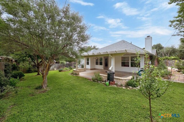9100 Brimstone Ln, Austin, TX 78717 - back of property with a patio area, a chimney, a shingled roof, and stucco siding