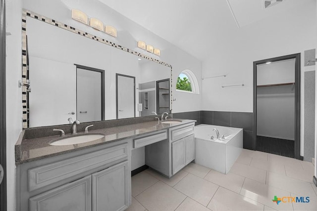 9100 Brimstone Ln, Austin, TX 78717 - full bathroom with double vanity, a garden tub, tile patterned floors, and a walk in closet