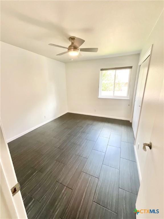 9100 Brimstone Ln, Austin, TX 78717 - unfurnished bedroom with dark wood finished floors and a ceiling fan