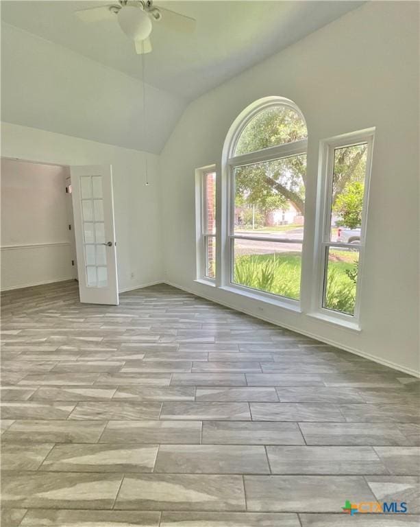 9100 Brimstone Ln, Austin, TX 78717 - unfurnished room featuring a ceiling fan, wood tiled floors, vaulted ceiling, and french doors