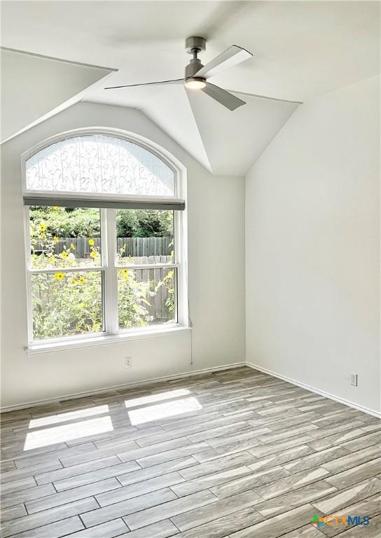 9100 Brimstone Ln, Austin, TX 78717 - unfurnished room with a ceiling fan, wood finished floors, and lofted ceiling