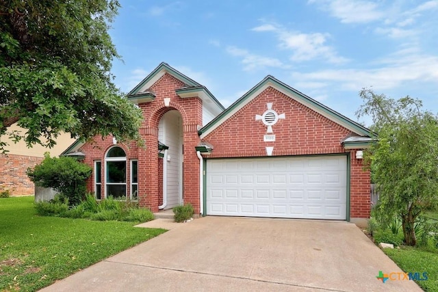 9100 Brimstone Ln, Austin, TX 78717 - traditional-style house with brick siding, driveway, a front yard, and an attached garage