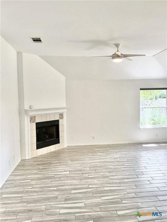 9100 Brimstone Ln, Austin, TX 78717 - unfurnished living room with ceiling fan, light wood-style flooring, and a fireplace
